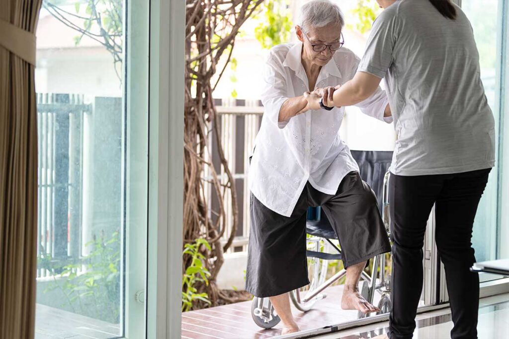 Old woman being helped up stair