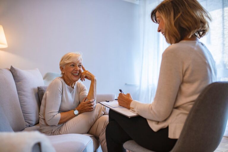 Older woman sitting with therapist
