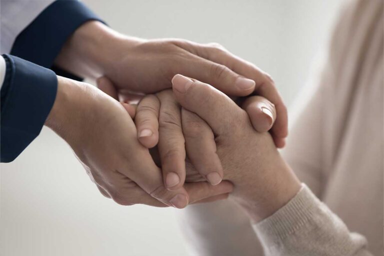 Person's hands held by another person