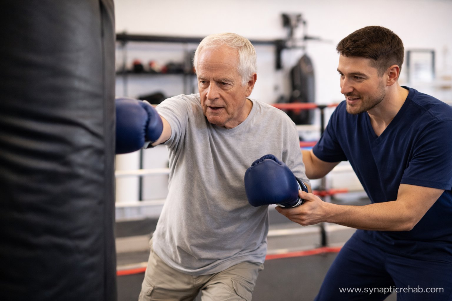 Older adult with Parkinson’s wearing boxing gloves